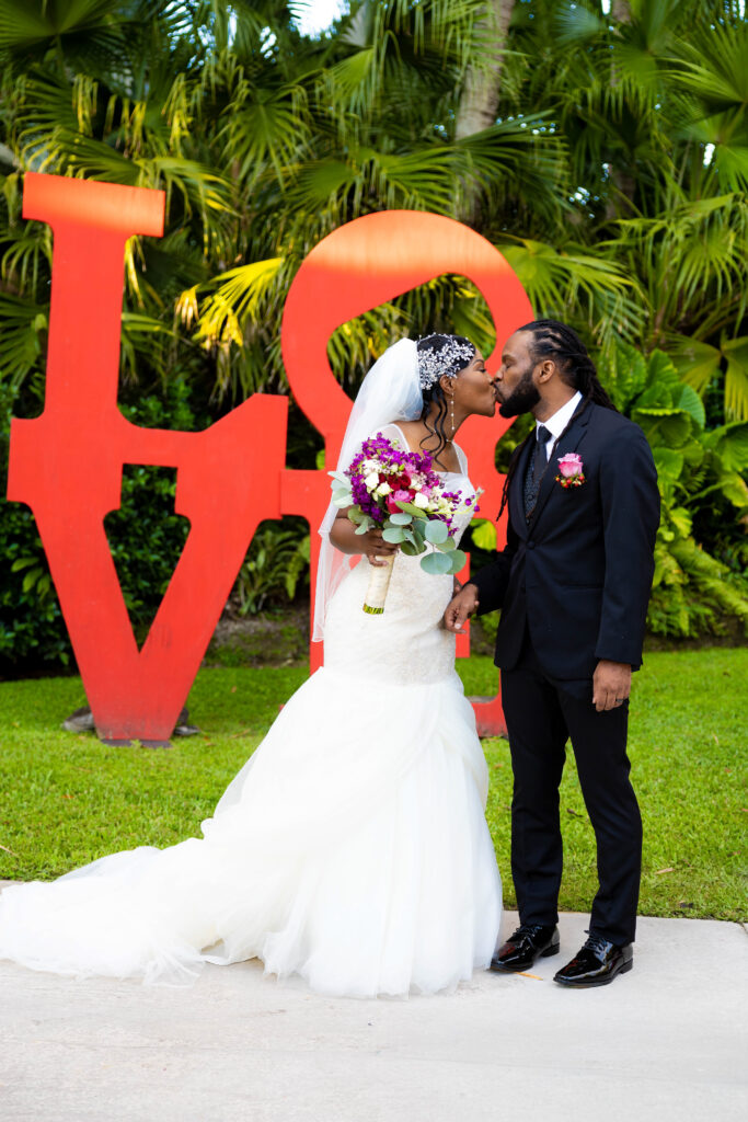 couple kissing at secret gardens miami
