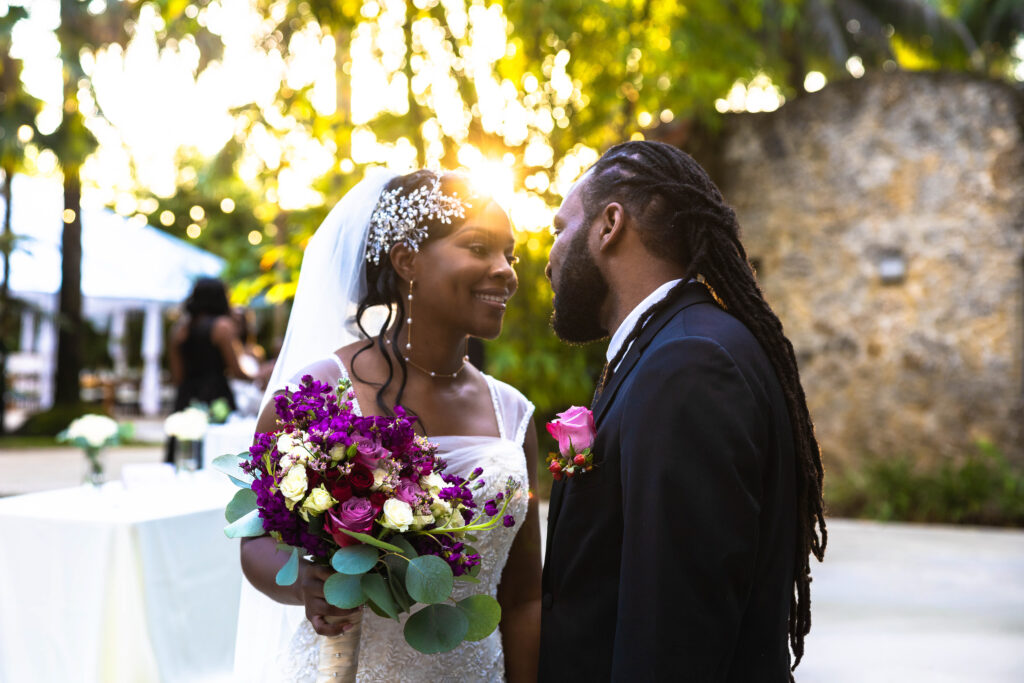 Kim and Kashka’s Secret Gardens Miami wedding ceremony under tropical greenery.